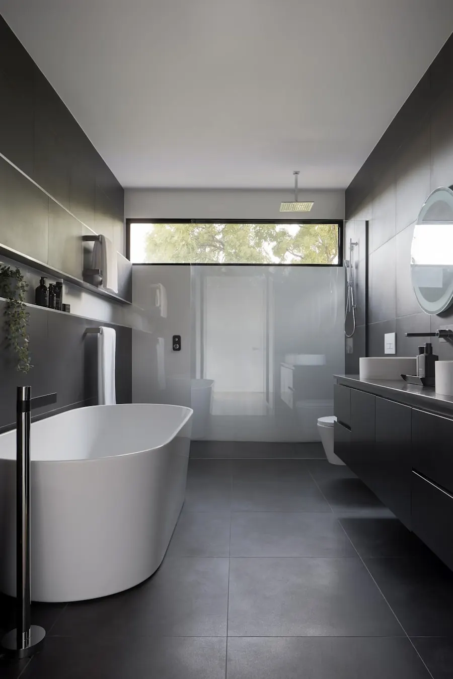 Calm fitted bathroom with stone, brass and hidden storage