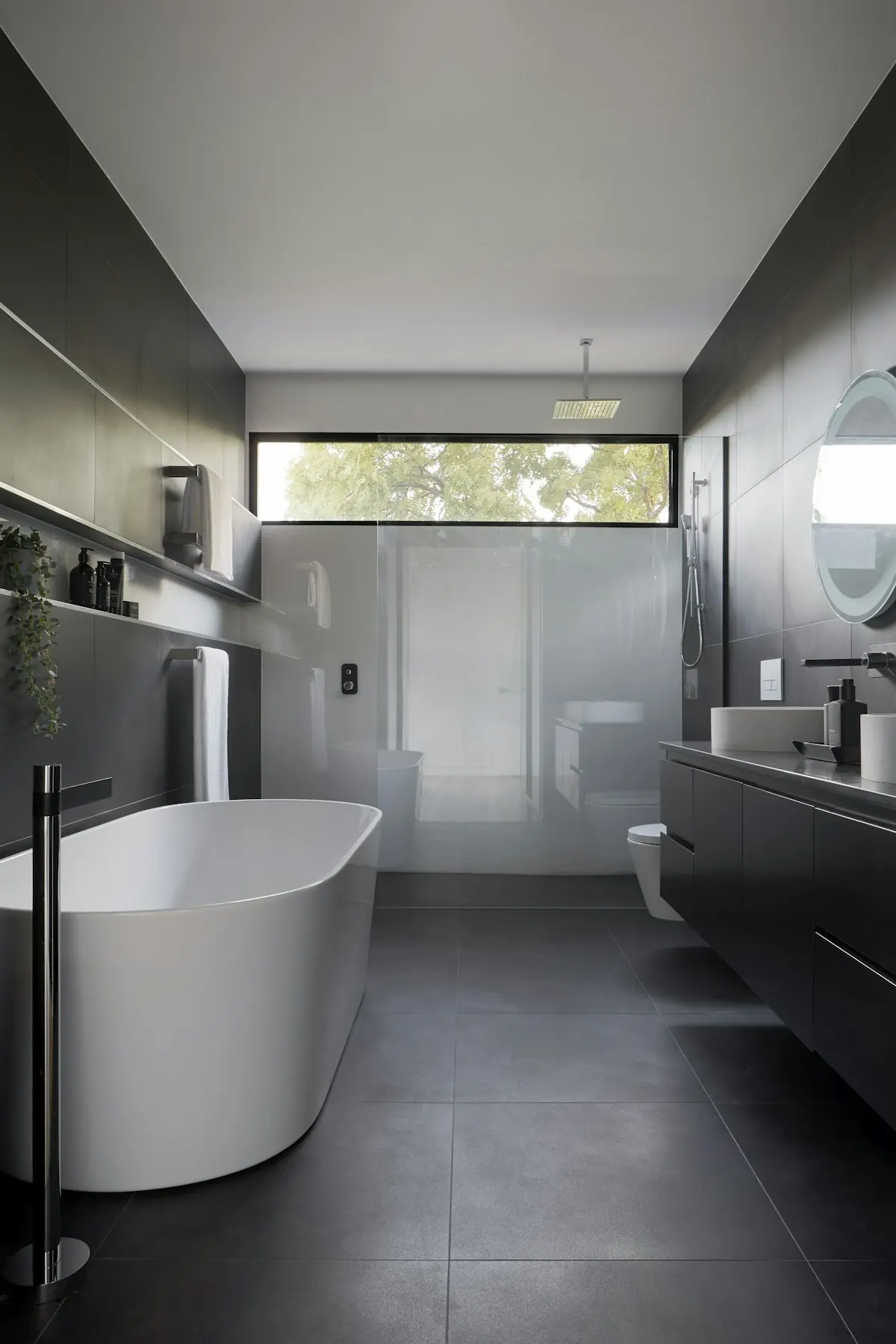 Stone bathroom with walk-in shower and brass fittings