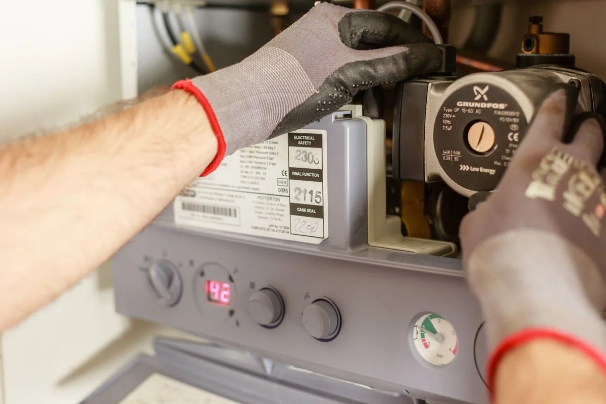 Heating engineer checking a domestic boiler