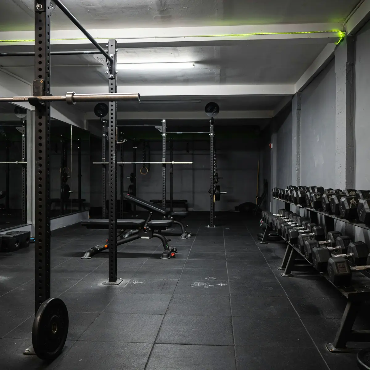 Ironworks Fitness free weights area with squat racks and dumbbells