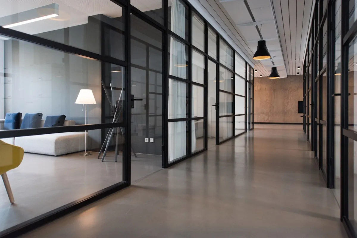 Open studio space with tables, books and large industrial windows