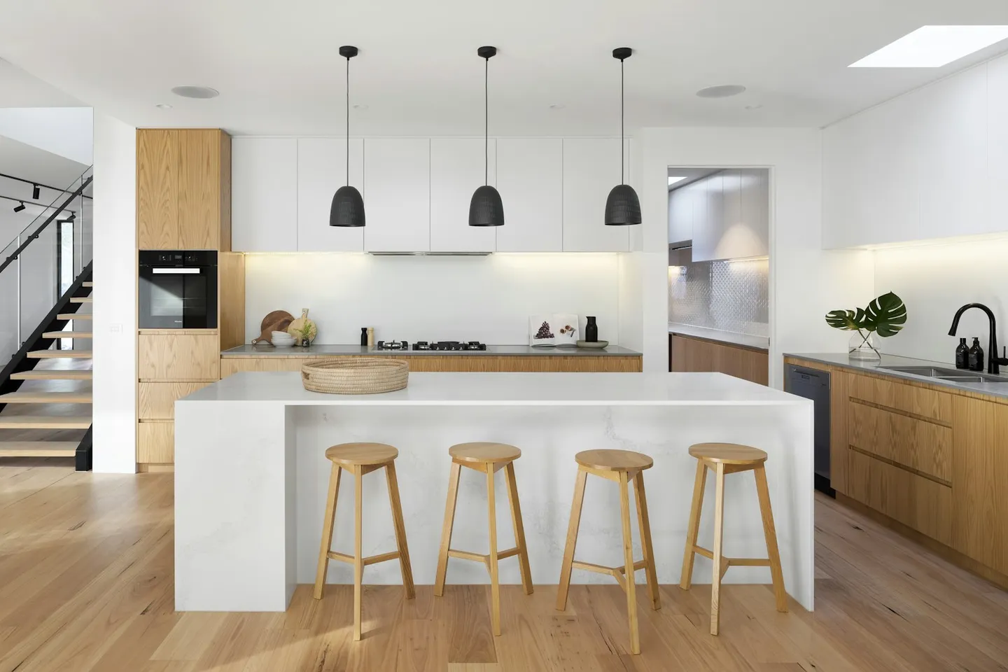 Light-filled living space with tall glazing and restrained interior finishes