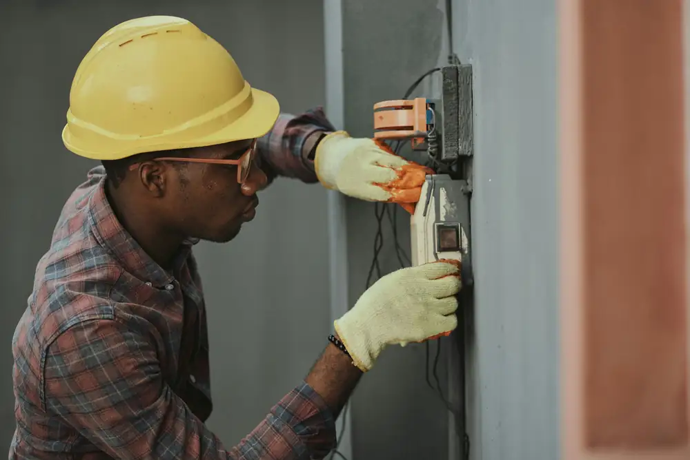 Electrician checking wiring inside a consumer unit