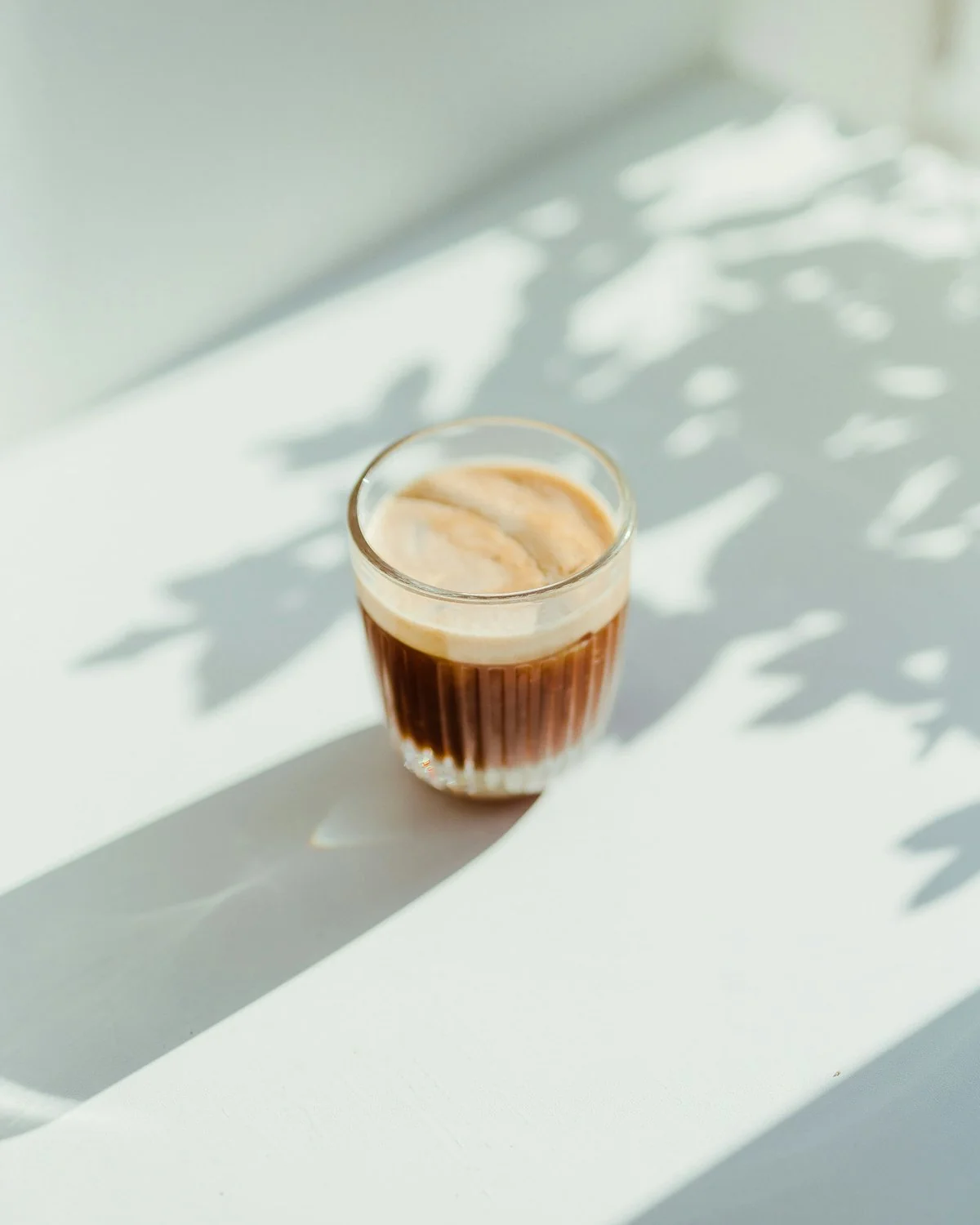 Barista preparing coffee behind a warm cafe counter
