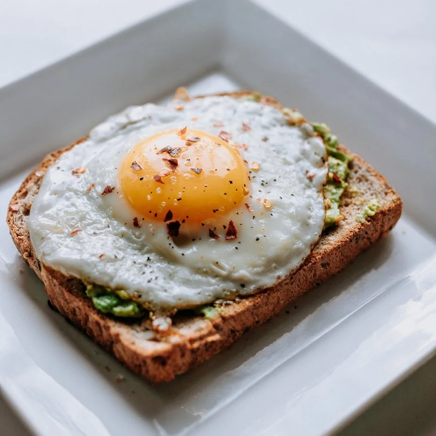 Brunch plate with eggs, toast and greens