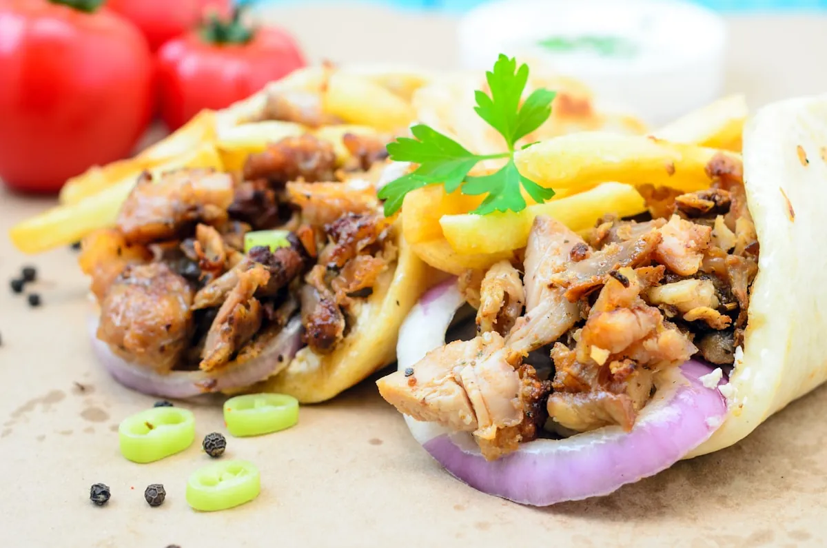Shish kebab served with flatbread and salad